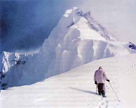 
Hermann Buhl On Broad Peak Col on first summit attempt May 29, 1957 with the main summit on the left and the Forepeak on the right. Fritz Winterstellar And Kurt Diemberger are climbing towards the Forepeak. - Broad Peak book
